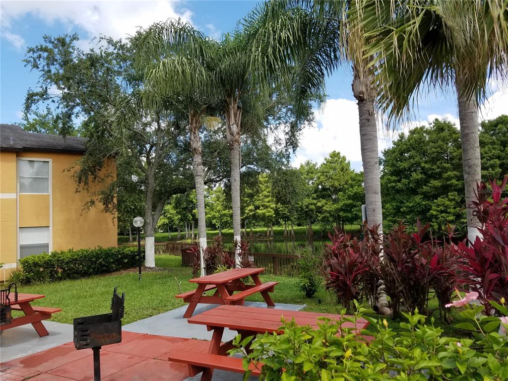 4572 Commander Drive, Unit 1237 Orlando, FL 32822 - Photo 2 of 31 a garden view with a seating space