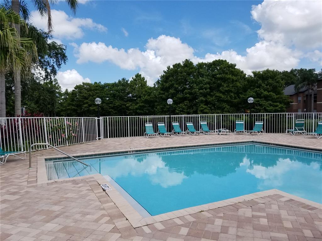 4572 Commander Drive, Unit 1237 Orlando, FL 32822 - Photo 25 of 31 a view of a swimming pool with a lounge chair