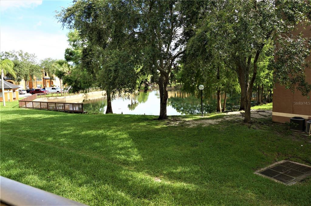4572 Commander Drive, Unit 1237 Orlando, FL 32822 - Photo 30 of 31 a view of yard with swimming pool and green space
