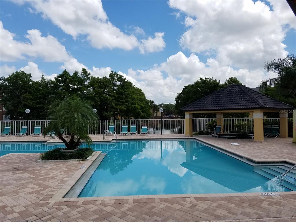 4572 Commander Drive, Unit 1237 Orlando, FL 32822 - Photo 3 of 31 a view of a house with swimming pool and sitting area