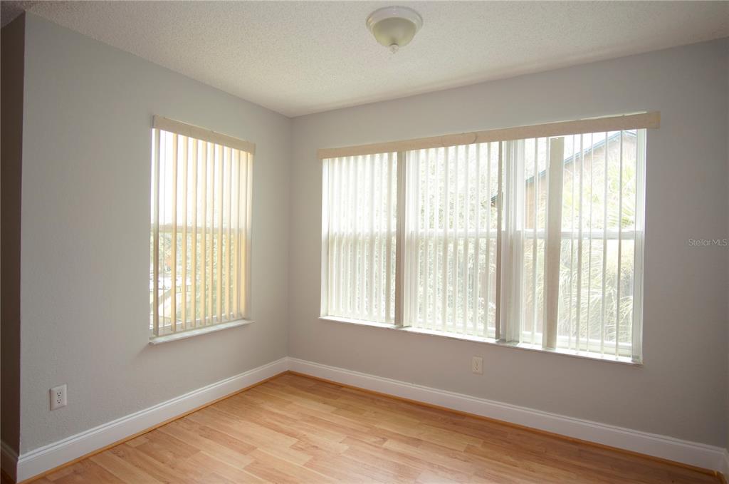 4572 Commander Drive, Unit 1237 Orlando, FL 32822 - Photo 5 of 31 a view of an empty room with wooden floor and a window