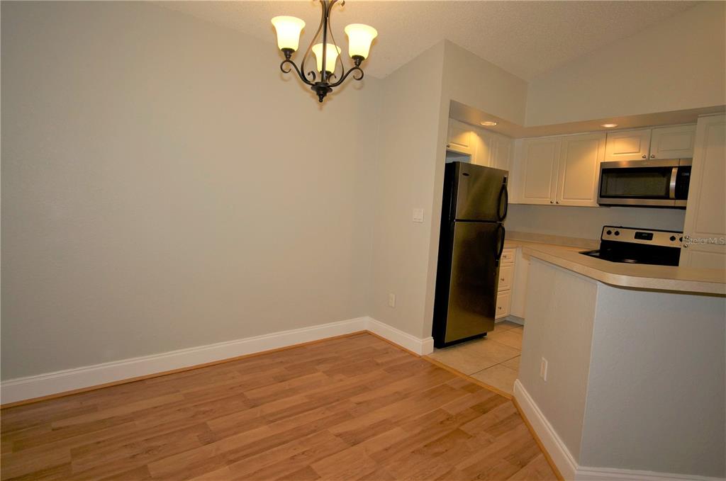 4572 Commander Drive, Unit 1237 Orlando, FL 32822 - Photo 6 of 31 a view of a kitchen with a microwave and cabinets