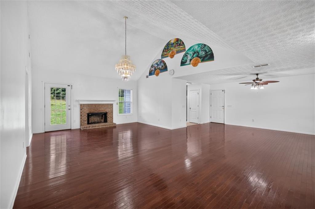 602 Pendergrass Road Winder, GA 30680 - Photo 11 of 44 a view of a livingroom with wooden floor a fireplace and window