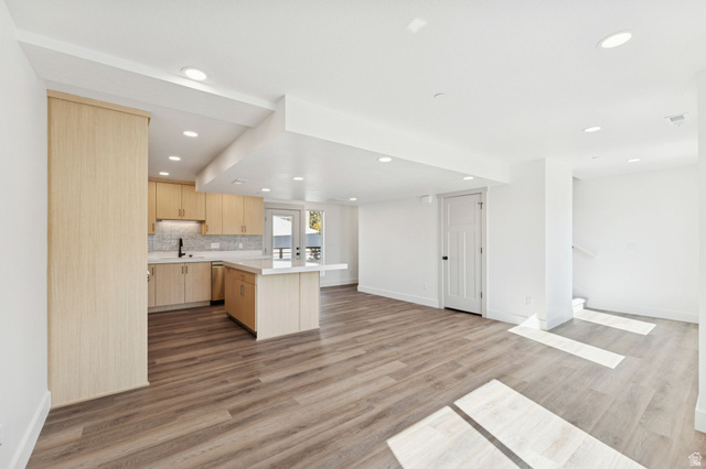 254 North Main Street Bountiful, UT 84010 - Photo 45 of 45 Kitchen featuring light brown cabinets, open floor plan, backsplash, light wood-style flooring, and recessed lighting