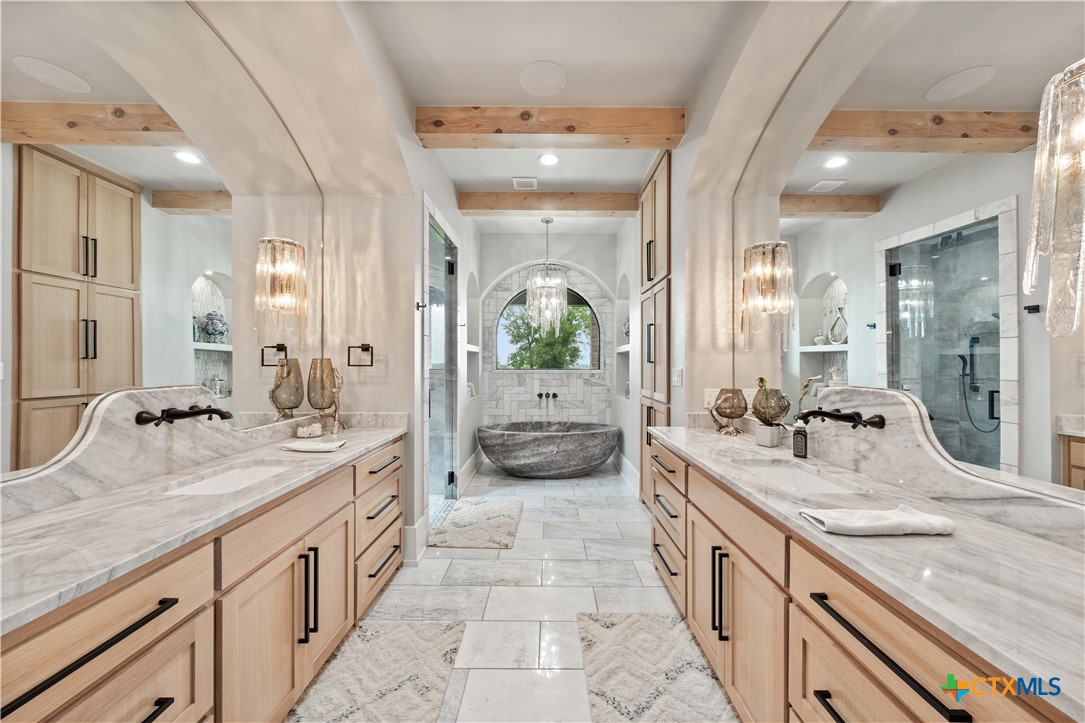 19102 Post Oak Road Bartlett, TX 76511 - Photo 19 of 43 a spacious en suite bathroom with double sink and a large mirror