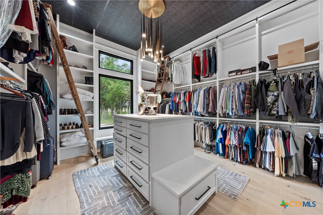 19102 Post Oak Road Bartlett, TX 76511 - Photo 25 of 43 a view of walk in closet with clothes and shoes