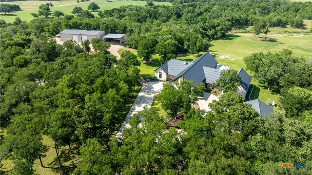 a view of a house with swimming pool and a yard