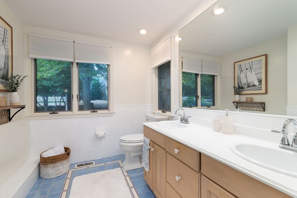 233 Hooppole Road Mashpee, MA 02649 - Photo 11 of 41 a bathroom with a double vanity sink toilet mirror and window