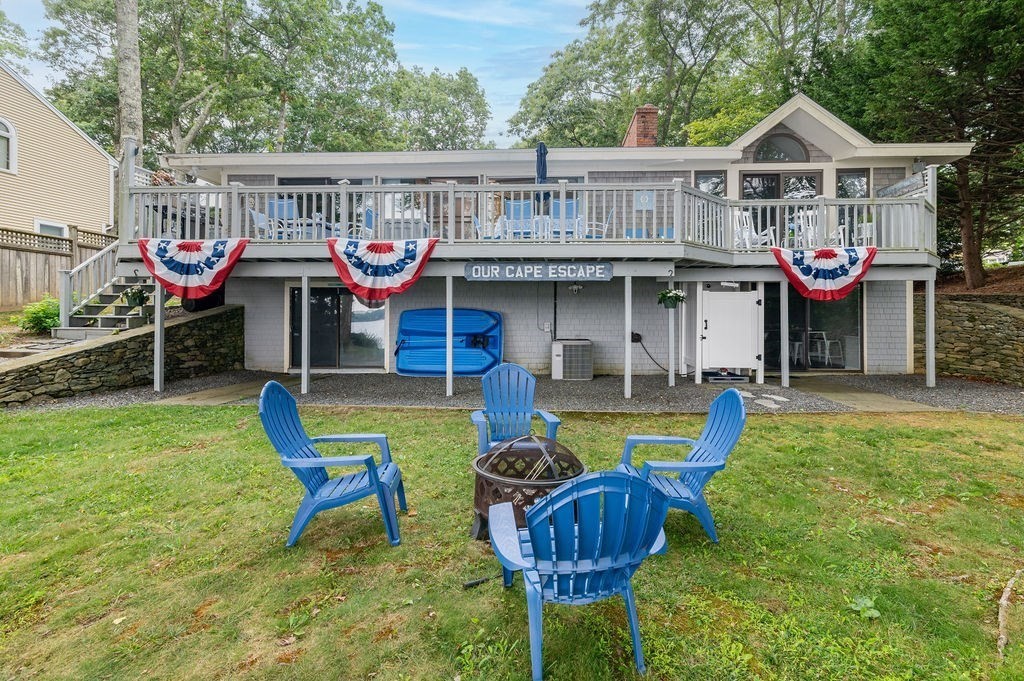 233 Hooppole Road Mashpee, MA 02649 - Photo 27 of 41 a front view of a house with garden and chairs
