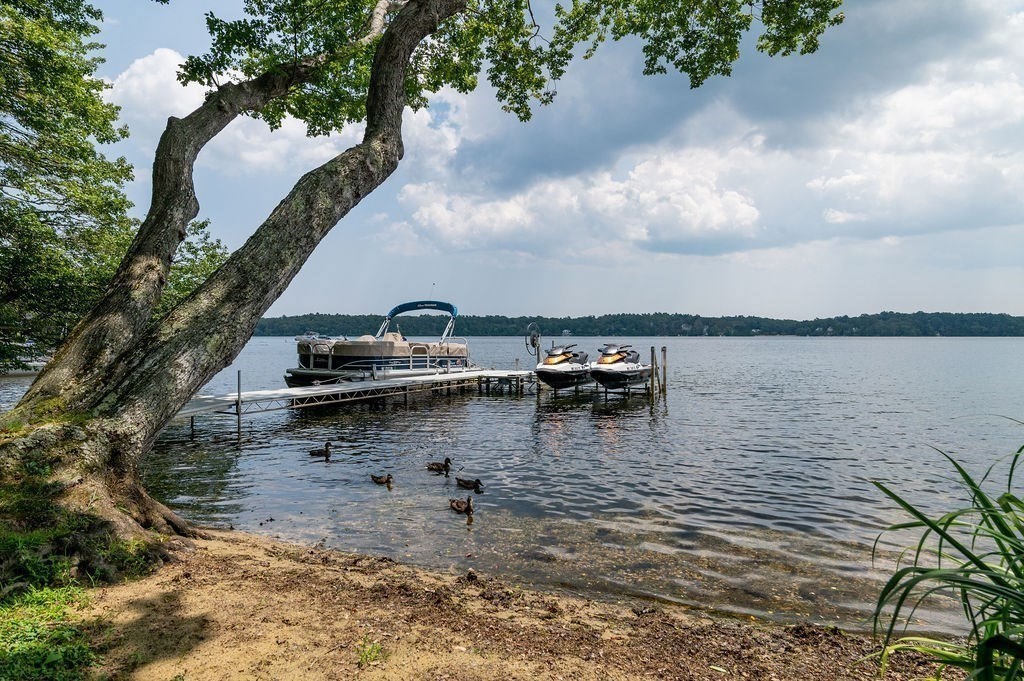 233 Hooppole Road Mashpee, MA 02649 - Photo 30 of 41 a view of a lake with boats in front of house