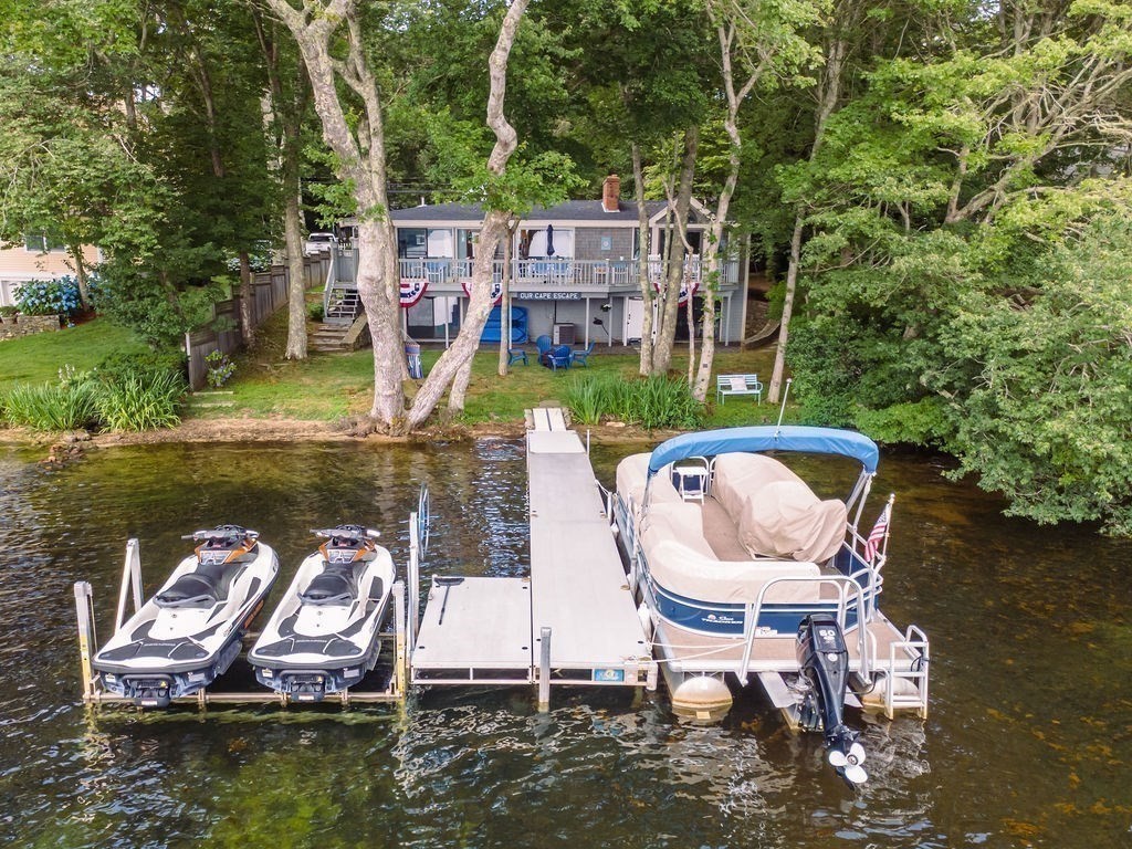 233 Hooppole Road Mashpee, MA 02649 - Photo 34 of 41 a view of a lake with a chairs in a lake