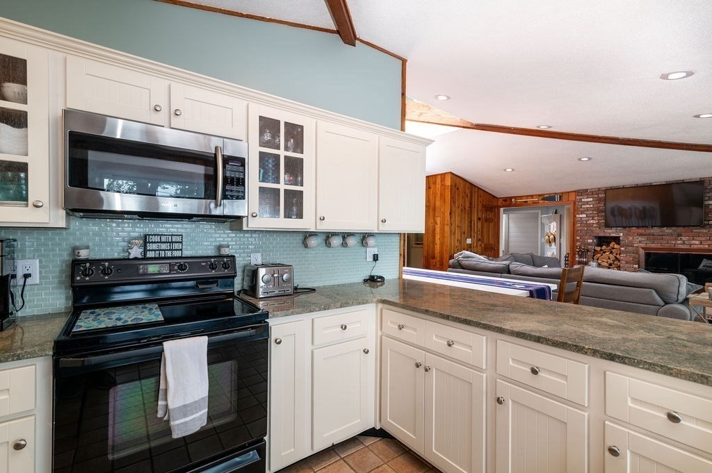233 Hooppole Road Mashpee, MA 02649 - Photo 8 of 41 a kitchen with stainless steel appliances granite countertop a stove a sink and a microwave