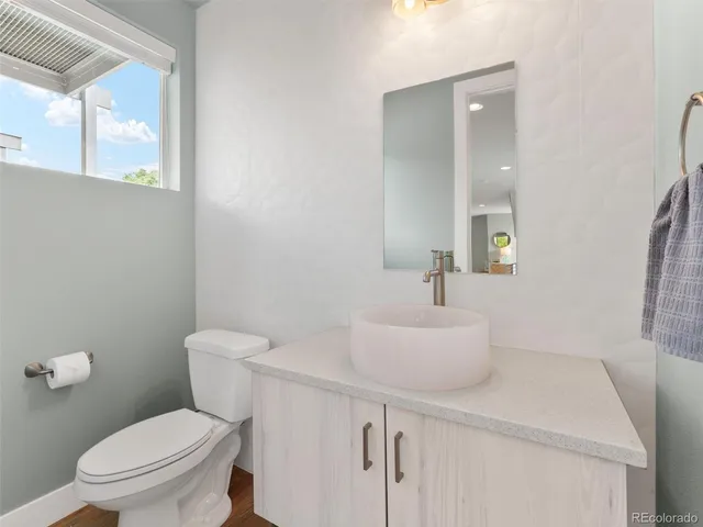 a white toilet sitting next to a bathroom sink