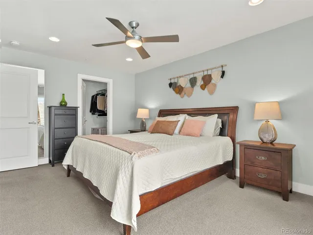 a spacious bathroom with a double vanity sink a large mirror a bathtub and shower