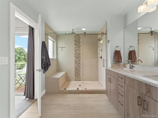a bathroom with a double vanity sink and a mirror