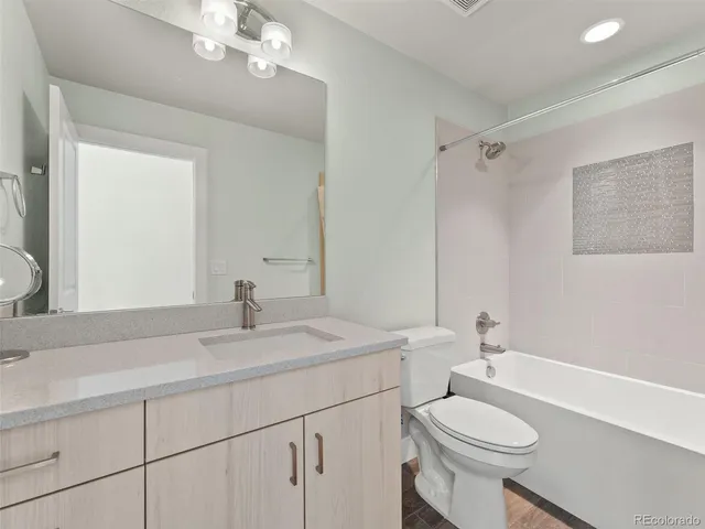 a room with furniture a flat screen tv and a floor to ceiling window