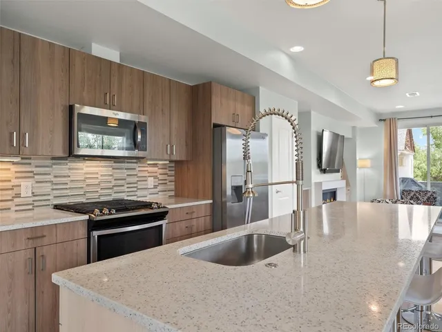 a kitchen with granite countertop a stove and a sink