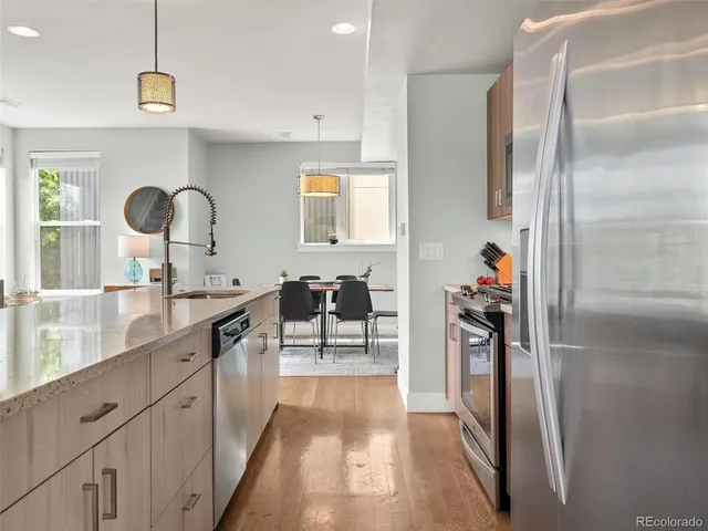a kitchen with stainless steel appliances granite countertop a refrigerator and a sink