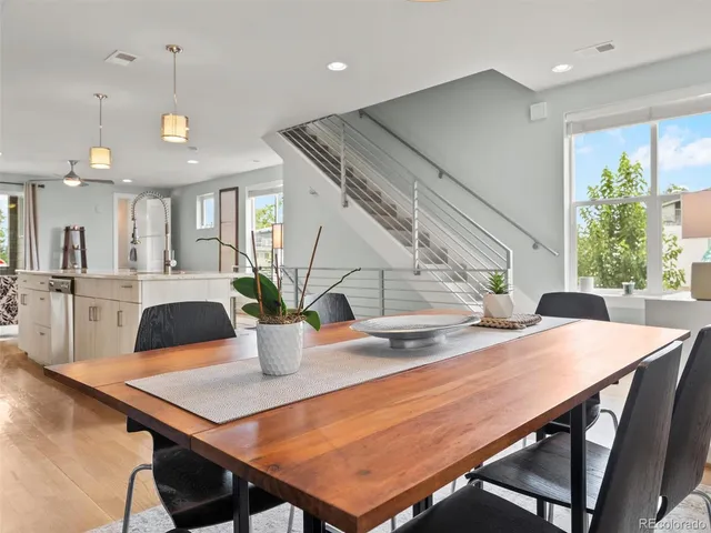 a view of a dining room with furniture and a chandelier