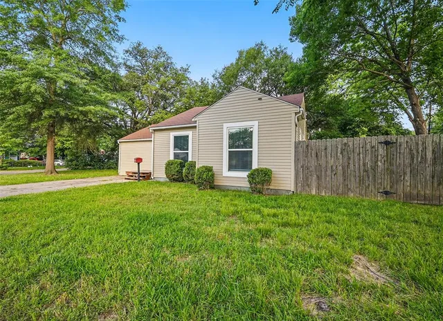 a front view of house with yard and green space