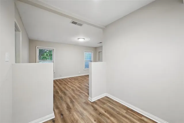 a view of hallway with wooden floor