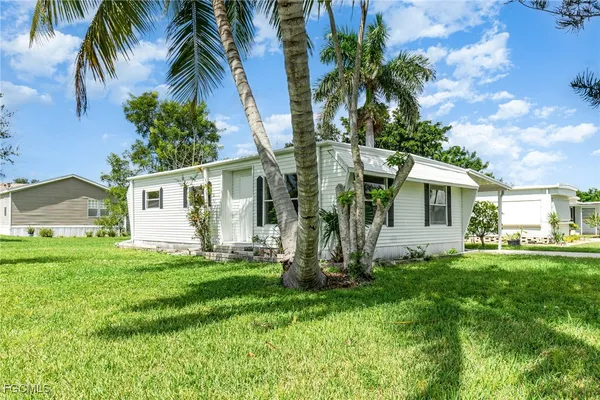 a front view of house with yard and seating area