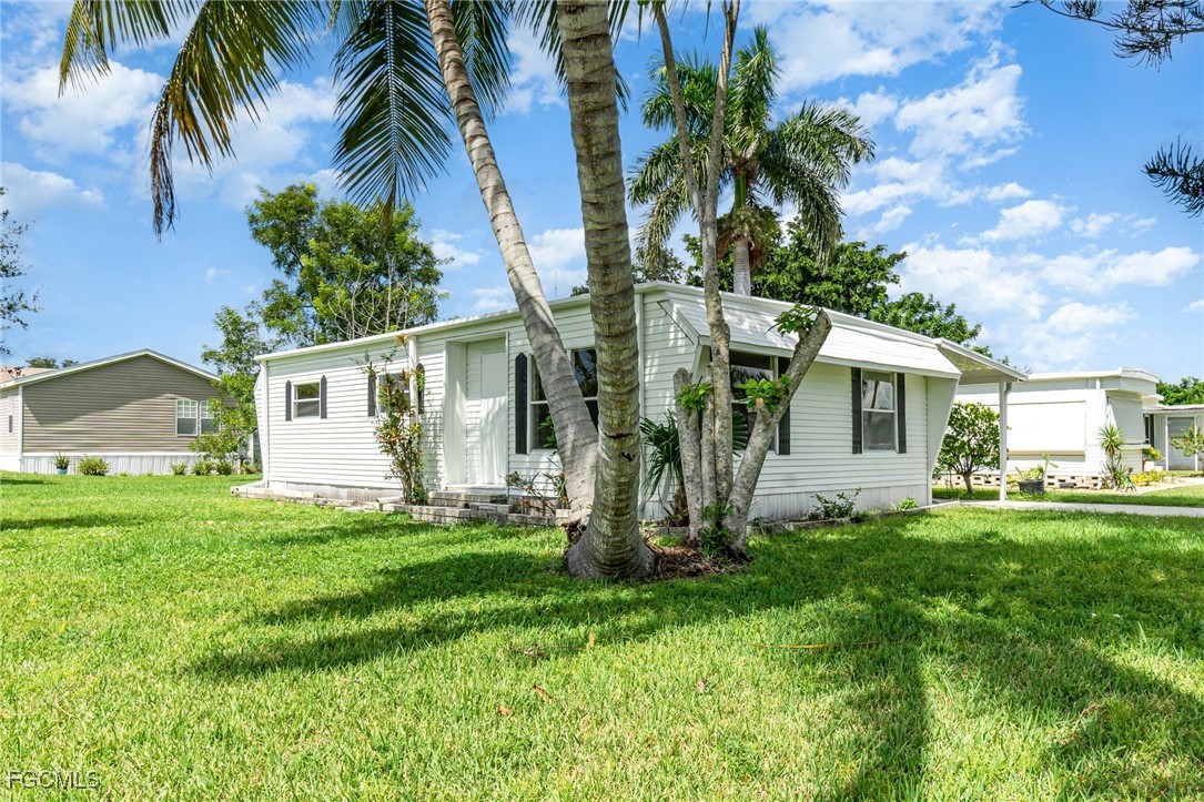 a front view of house with yard and seating area