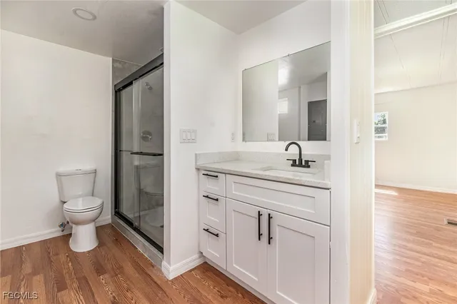 a bathroom with a toilet a sink and a mirror