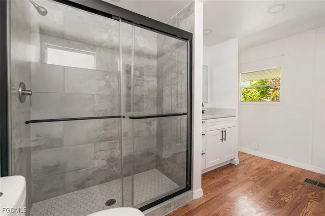 a bathroom with a glass shower door