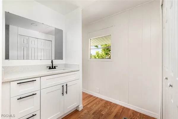 a bathroom with a sink and a mirror
