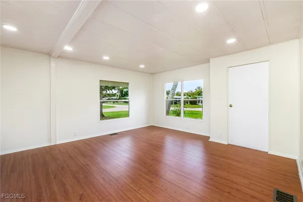 a view of room with window and wooden floor