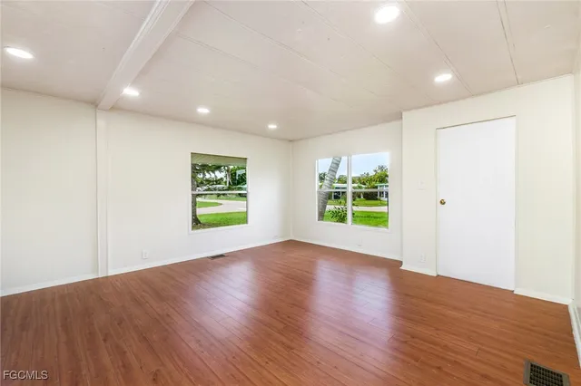 a view of room with window and wooden floor