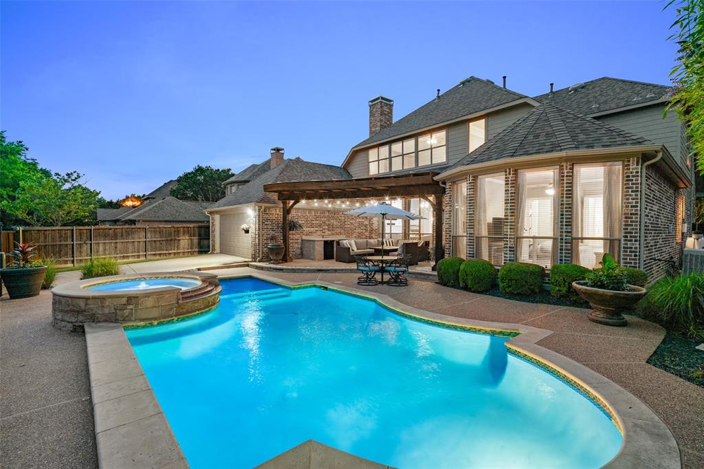 a view of a house with swimming pool and sitting area