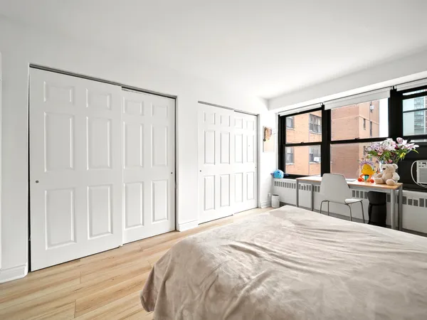 a bedroom with a large bed and a window