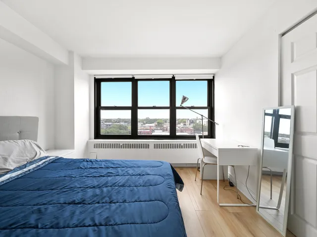 a spacious bedroom with a large bed and a large window