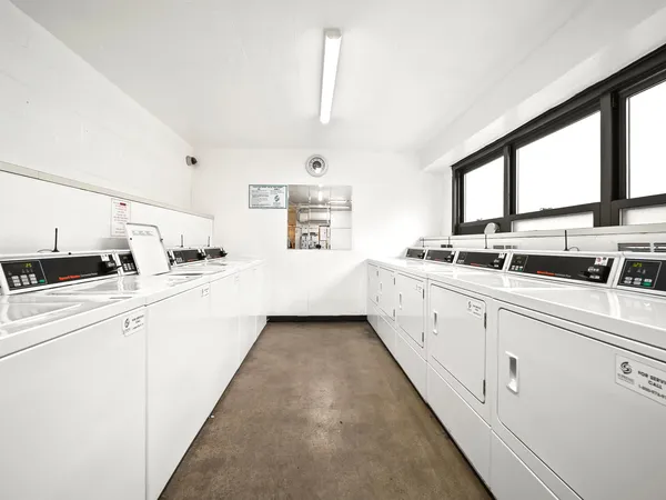 a large white kitchen with sink and window