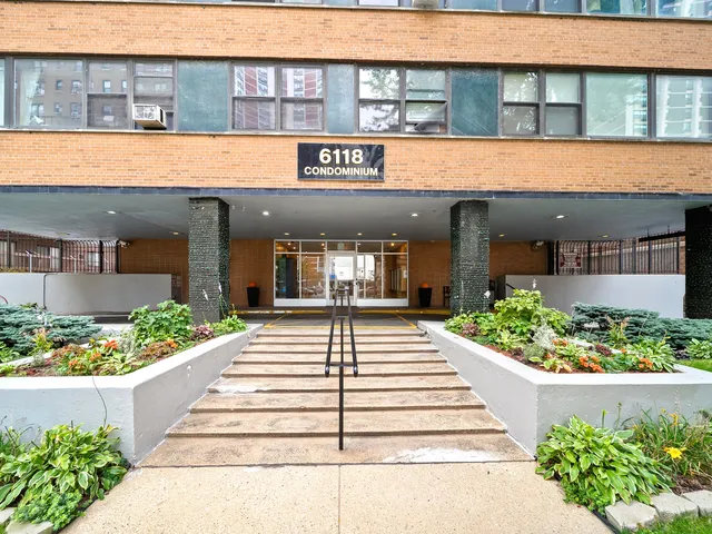 a front view of a building with a garden