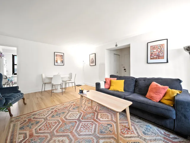 a living room with furniture and a rug