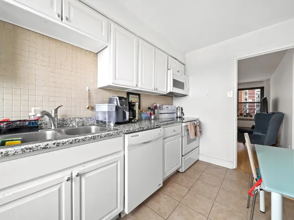 a kitchen with stainless steel appliances granite countertop a sink and cabinets