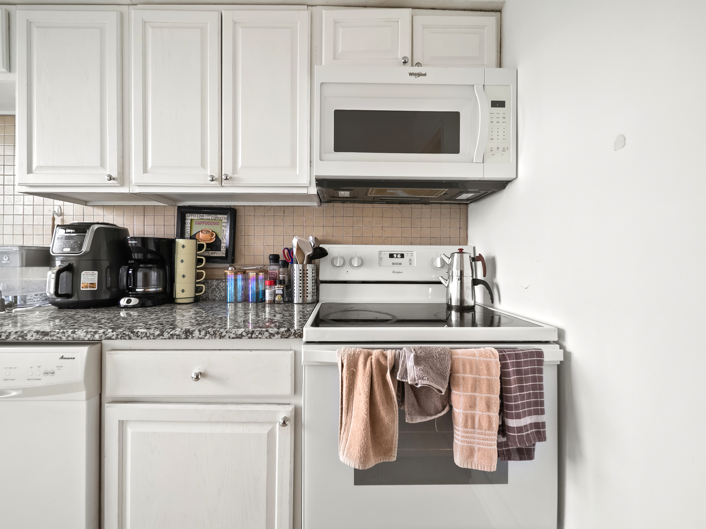 6118 North Sheridan Road, Unit 1008 Chicago, IL 60660 - Photo 9 of 19 a kitchen with stainless steel appliances granite countertop white cabinets and a stove