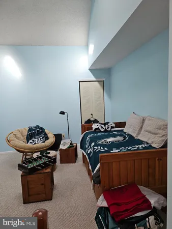 a bedroom with furniture and a mirror