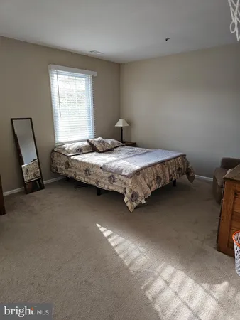 a bedroom with bed and window