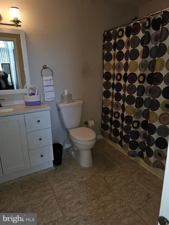 a bathroom with a toilet and a mirror