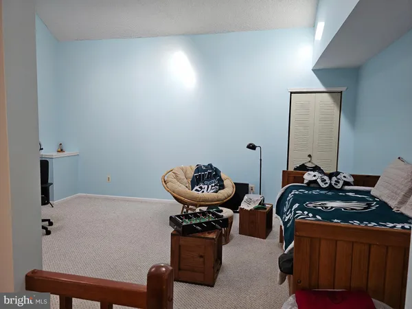 a bedroom with bed and a table