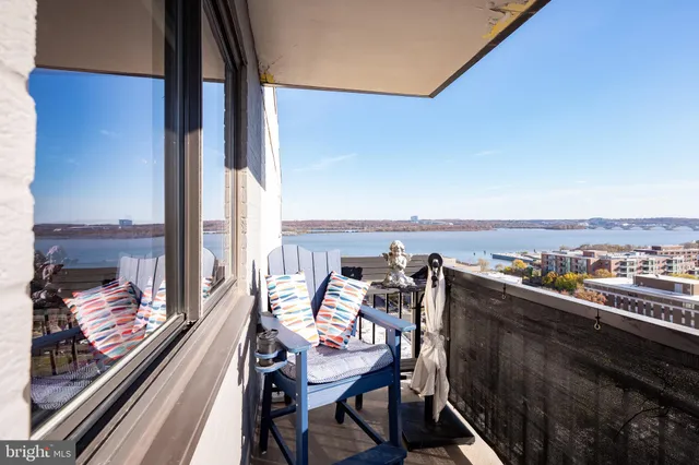a view of a balcony with chair and wooden floor