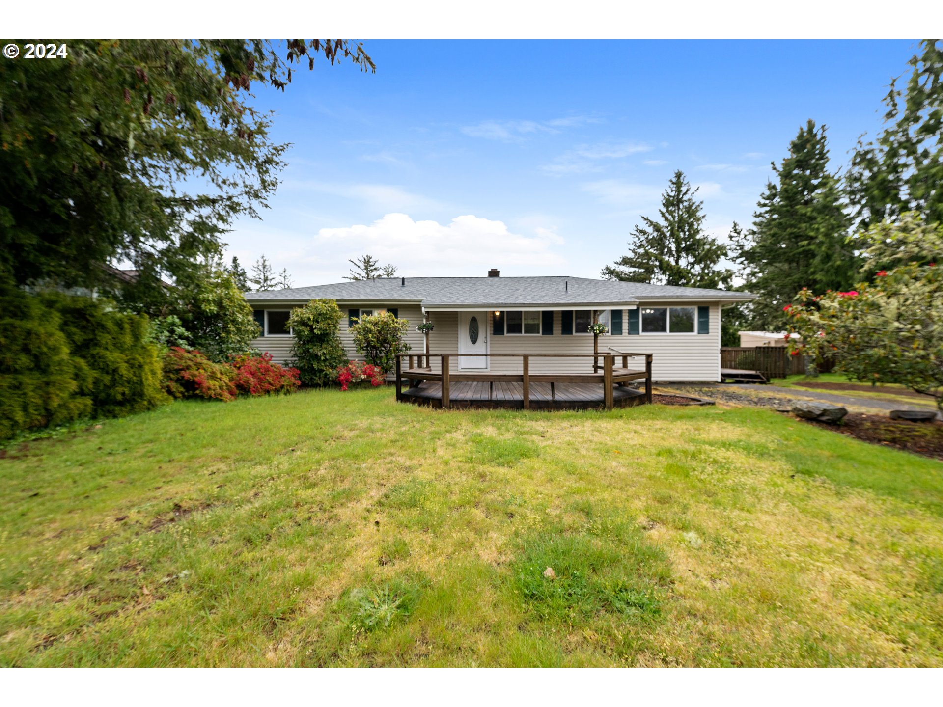 a front view of house with yard and trees
