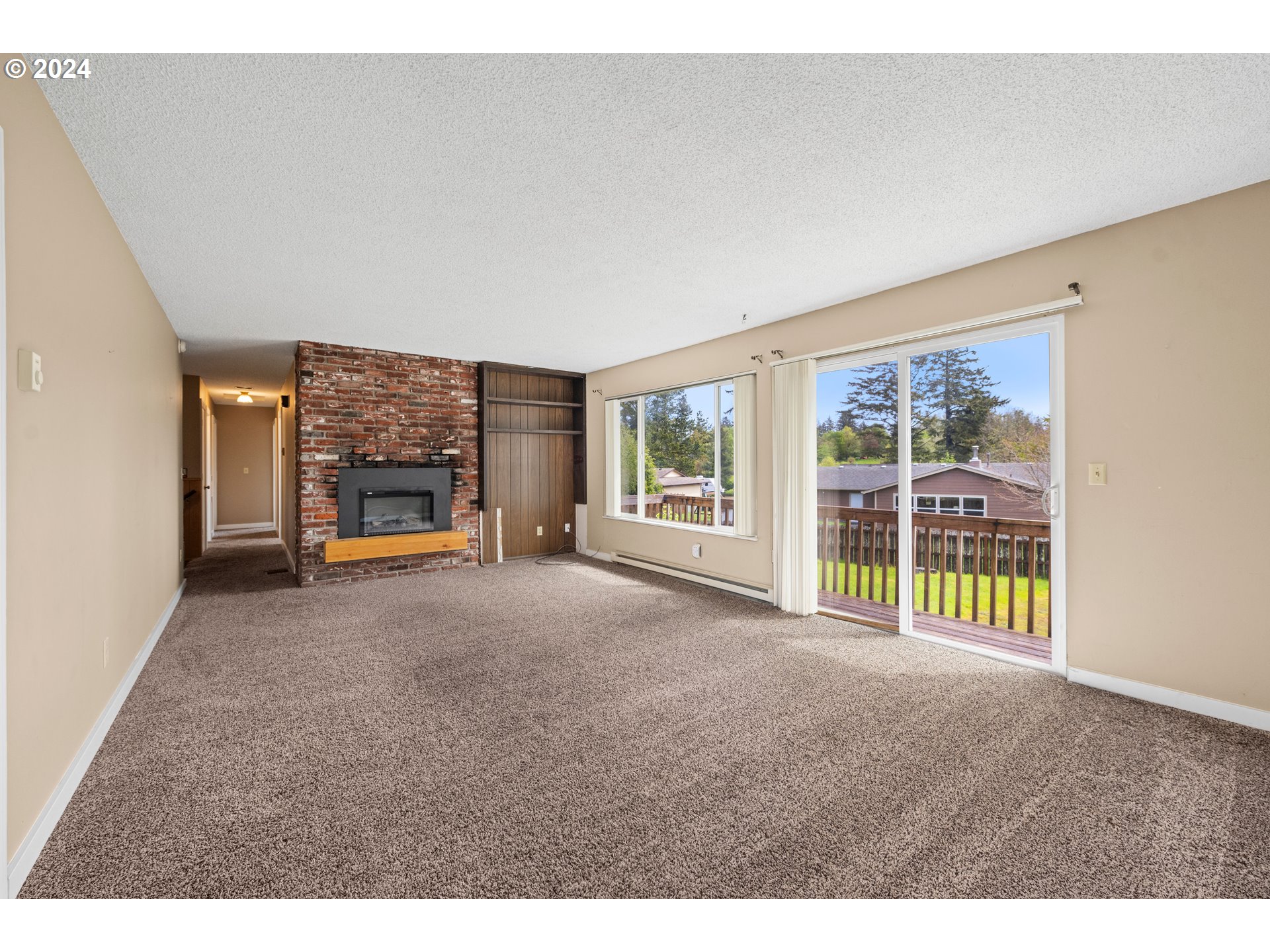 91897 Ridge Road Warrenton, OR 97146 - Photo 11 of 24 a view of an empty room with a fireplace