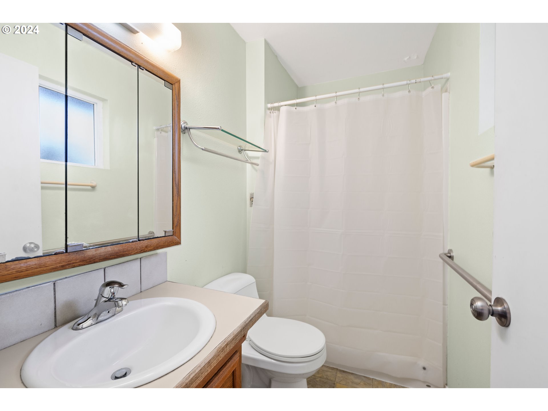 91897 Ridge Road Warrenton, OR 97146 - Photo 15 of 24 a bathroom with a sink and a mirror