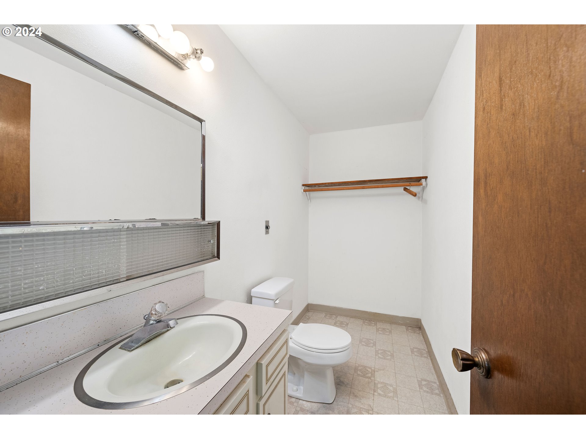 91897 Ridge Road Warrenton, OR 97146 - Photo 20 of 24 a bathroom with a sink and a mirror