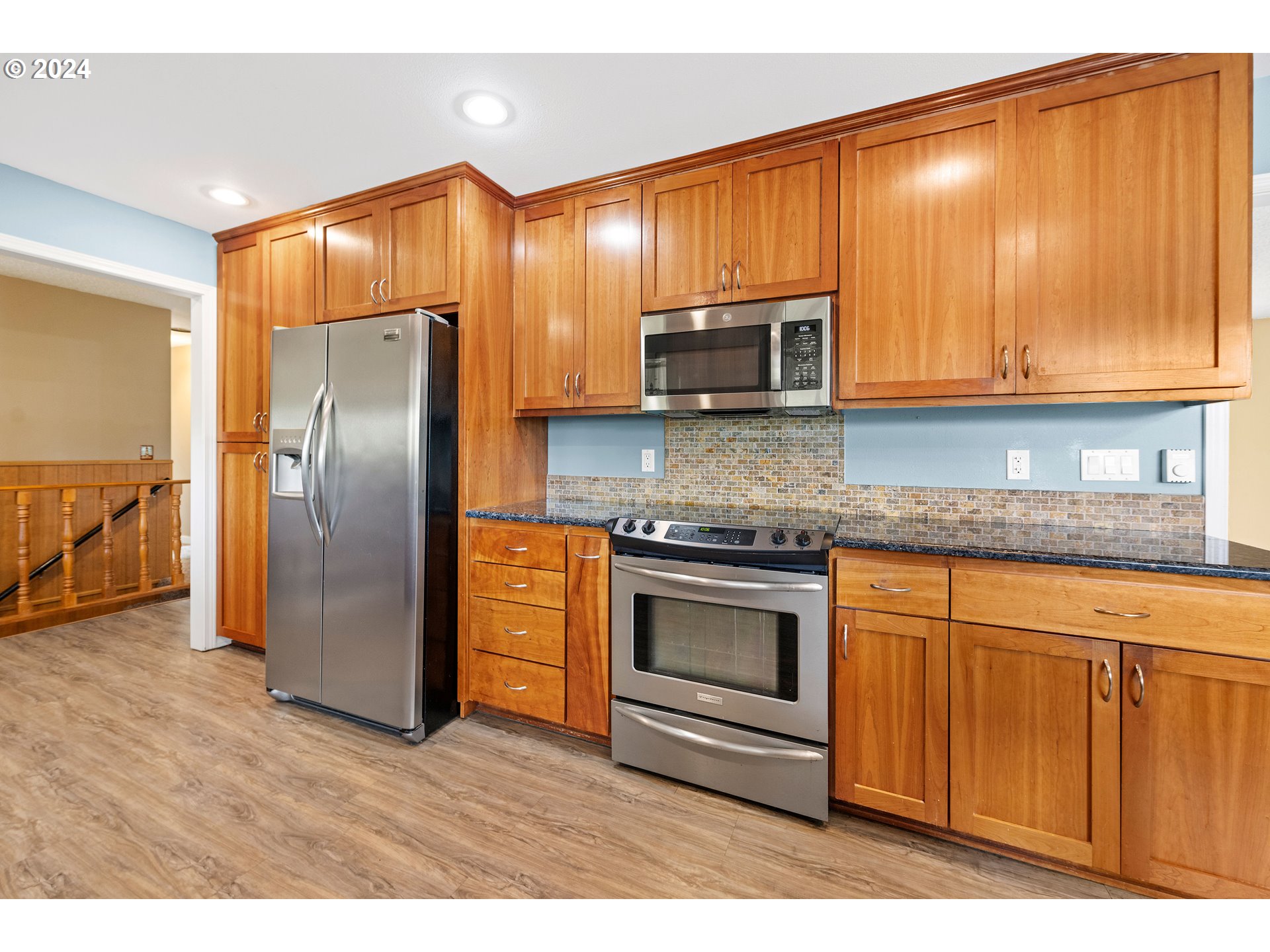91897 Ridge Road Warrenton, OR 97146 - Photo 6 of 24 a kitchen with stainless steel appliances granite countertop a refrigerator a stove a sink and a microwave